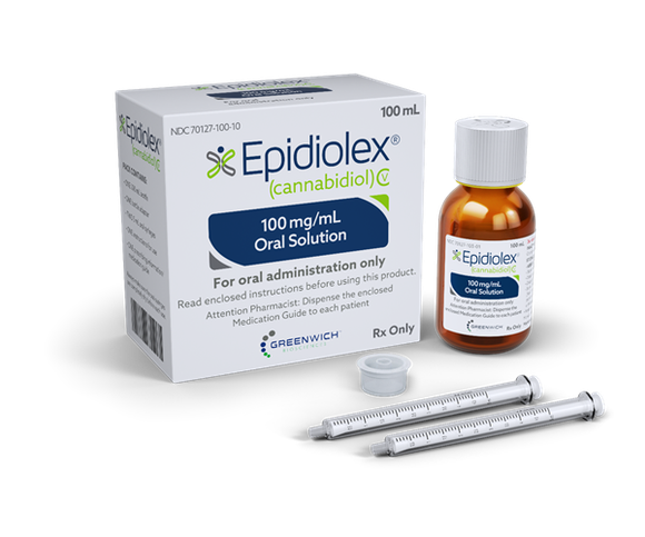 A bottle of Epidiolex, next to its packaging and two droppers.
