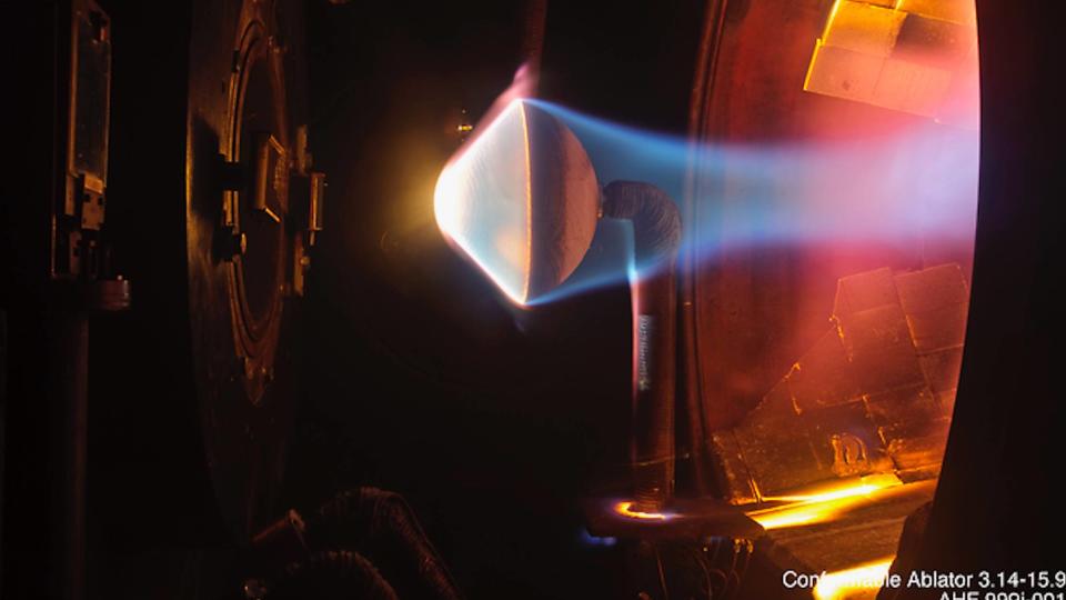 Close-up of a blue flame inside a test chamber in a research laboratory