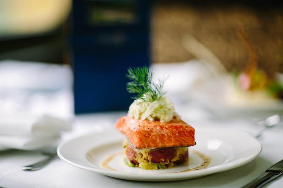 <cite class="credit"><em>Photo by Rocky Mountaineer</em> | Rocky Mountaineer’s salmon with shaved-fennel ‘slaw, local-market vegetables and mustard vinaigrette</cite>