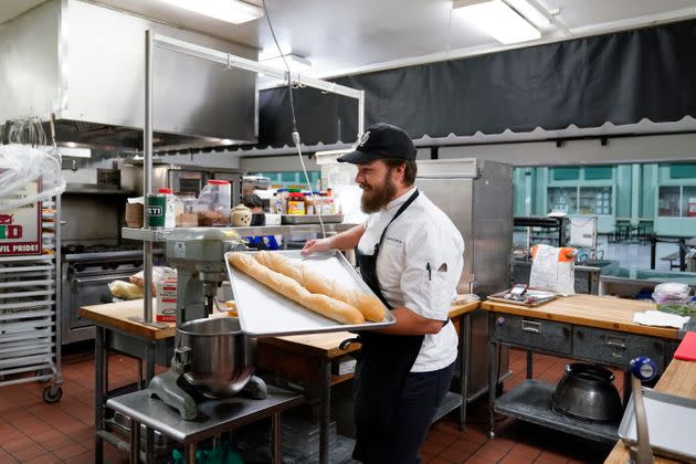 Chef Josh Gjersand moves two baguettes to the oven before preparing a salami sandwich for Mount Diablo High School students during a taste test in Concord, California, on Jan. 13.