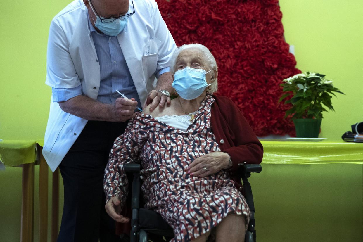 A nurse administers a COVID-19 vaccine to Josepha Delmotte, 102 years old, at La Bonne Maison de Bouzanton care home in Mons, Belgium on Monday, Dec. 28, 2020. The vaccine, developed by BioNTech and Pfizer, was transported from a hospital in Leuven to the residential care home on Monday, as Belgium begins its vaccination program starting with the most vulnerable.