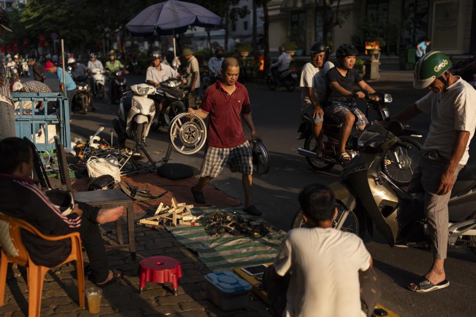 Shoppers and vendors crowd the street in Nhat Tao market, the largest informal recycling market in Ho Chi Minh City, Vietnam, Sunday, Jan. 28, 2024. (AP Photo/Jae C. Hong)