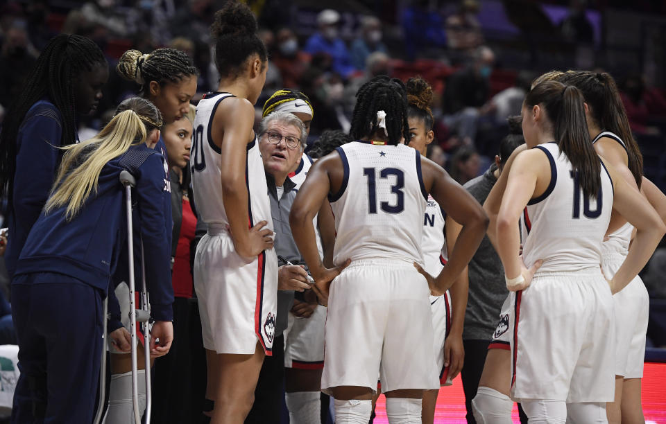 Connecticut head coach Geno Auriemma talks to his team during their women's college basketball game.