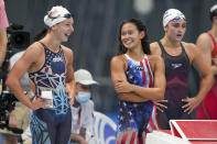 United States women's 4x200-meter freestyle relay team Paige Madden, left, Arabella Sims and Kathy McLaughlin, right, react during their heat at the 2020 Summer Olympics, Wednesday, July 28, 2021, in Tokyo, Japan. (AP Photo/Matthias Schrader)