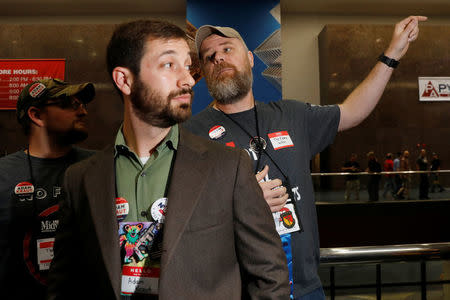 Gun rights proponents Adam Kraut (L) and Tim Harmsen, speak to NRA members about Kraut's candidacy for a seat on the board of the National Rifle Association (NRA) at the organisation's convention in Dallas, Texas, U.S., May 5, 2018. REUTERS/Lucas Jackson