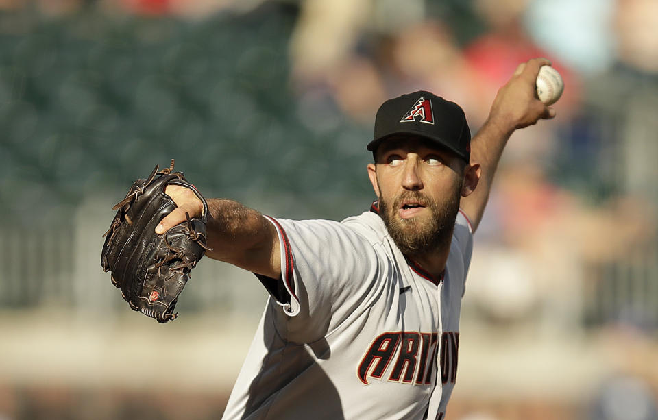 Arizona Diamondbacks pitcher Madison Bumgarner works against the Atlanta Braves in the seventh inning of the second baseball game of a doubleheader, Sunday, April 25, 2021, in Atlanta. (AP Photo/Ben Margot)