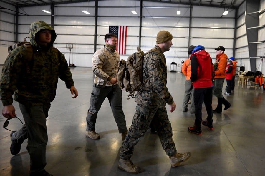 U.S. Marines leave a command center, Wednesday, Feb. 7, 2024, in Kitchen Creek, Calif. A Marine Corps helicopter that had been missing with five troops aboard as an historic storm continued drenching California was found Wednesday morning in a mountainous area outside San Diego. (AP Photo/Denis Poroy)