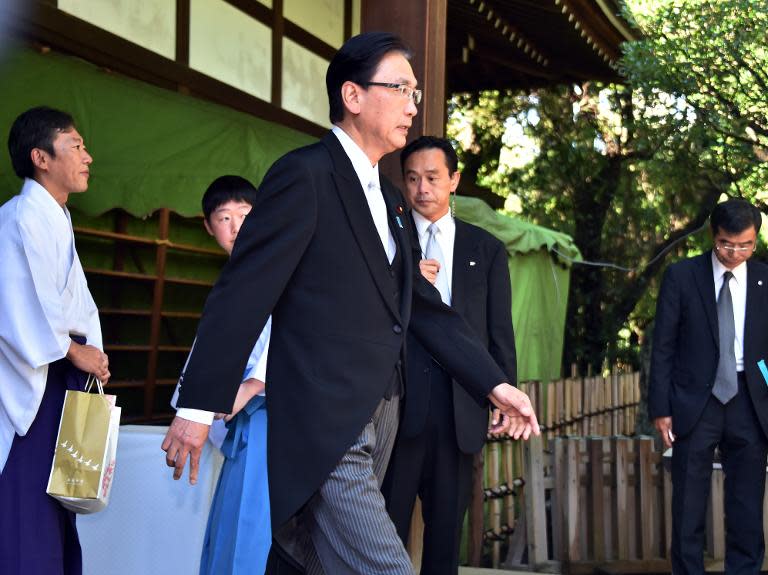 Japanese State Minister Keiji Furuya (C) leaves the controversial Yasukuni shrine in Tokyo on August 15, 2014, the 69th anniversary of Japan's surrender from World War II