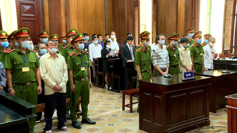 Defendants of Trieu Dai Viet group stand during their trial at a court in Ho Chi Minh City