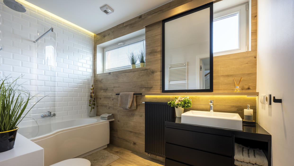  Modern small bathroom in stylish apartment white and wooden finishing. 