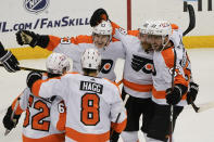 Philadelphia Flyers' Claude Giroux, second from right, celebrates with teammates after scoring goal against the Pittsburgh Penguins during the third period of an NHL hockey game Thursday, March 4, 2021, in Pittsburgh. (AP Photo/Keith Srakocic)