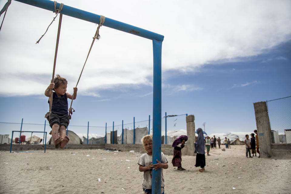 Children play at al-Hol camp that houses some 60,000 refugees, including families and supporters of the Islamic State group, many of them foreign nationals, in Hasakeh province, Syria, Saturday, May 1, 2021. Kurdish officials say security has improved at the sprawling camp in northeast Syria, but concerns are growing of a coronavirus outbreak in the facility. (AP Photo/Baderkhan Ahmad)