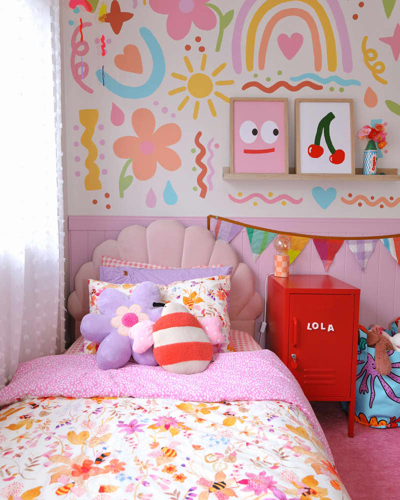 kids' room with shell headboard bed, and colorful wall mural and accents