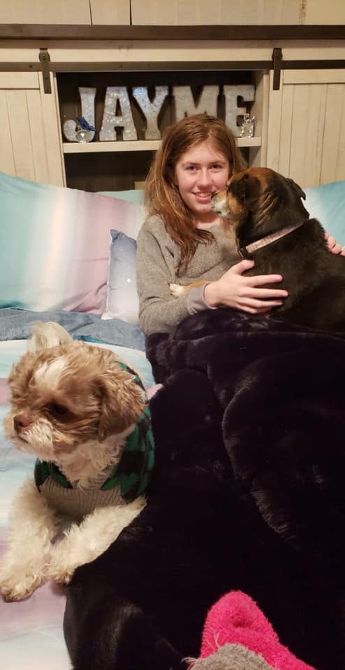 Jayme Closs smiles with the family pets at her aunt's home Saturday, two days after escaping from a cabin in Gordon in Douglas County. Authorities say Jayme  was kidnapped 88 days ago when her parents were murdered in her Barron home.