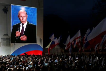 FILE PHOTO: Russian President Vladimir Putin addresses the audience during a rally marking the fourth anniversary of Russia's annexation of Ukraine's Crimea region in the Black Sea port of Sevastopol, Crimea, March 14, 2018. REUTERS/Maxim Shemetov/File Photo