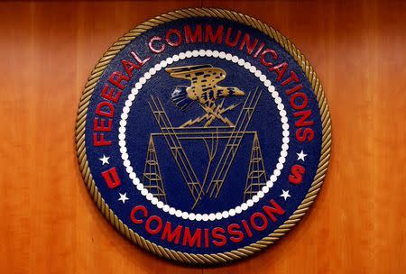 The Federal Communications Commission (FCC) logo is seen before the FCC Net Neutrality hearing in Washington February 26, 2015. REUTERS/Yuri Gripas