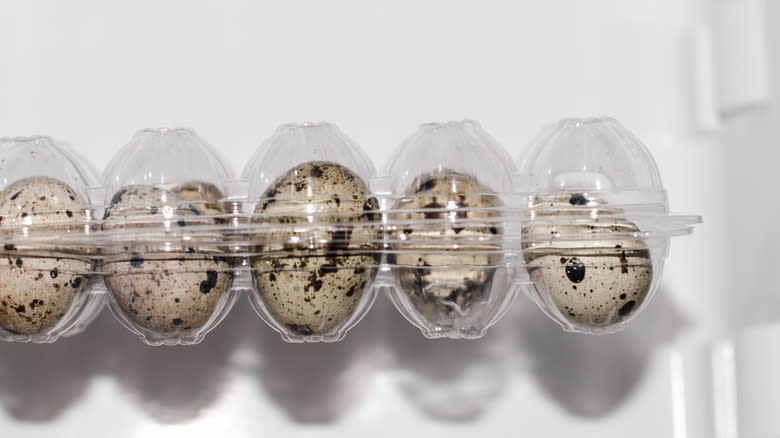 quail eggs in plastic container