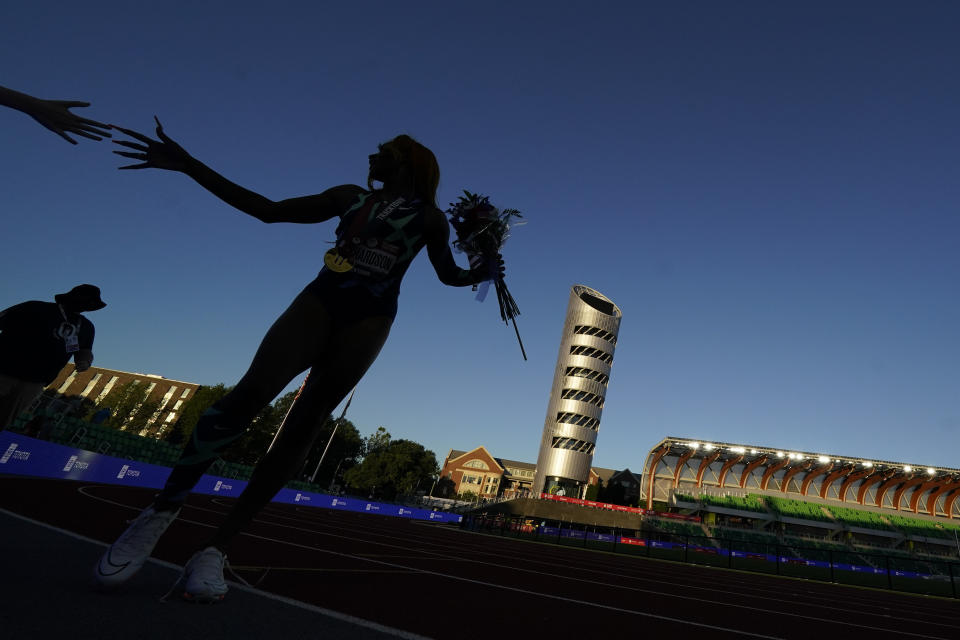 Sha'Carri Richardson greets fans after winning the women's 100-meter run at the U.S. Olympic Track and Field Trials Saturday, June 19, 2021, in Eugene, Ore. (AP Photo/Charlie Riedel)