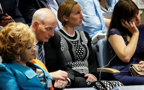 White House Chief of Staff Kelly checks his watch as he listens to U.S. President Trump deliver his address to the UN - Credit: Reuters