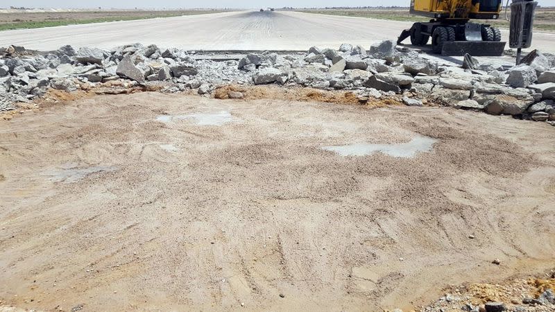 A heavy machine operates at the tarmac of Damascus International Airport