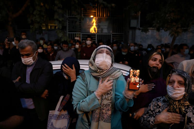 Fans of Mohammad Reza Shajarian mourn his death in front of Jam Hospital, in Tehran