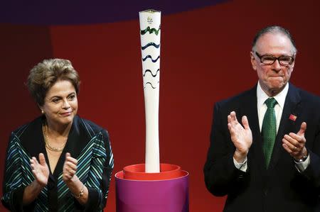 Brazil's President Dilma Rousseff (L) and Rio 2016 Olympic Games Organising Committee President Carlos Arthur Nuzman applaud next to an Olympic torch model during a ceremony where the Rio Organizing Committee presented the torch and relay route for the Rio 2016 Games in Brasilia, Brazil, July 3, 2015. REUTERS/Wenderson Araujo