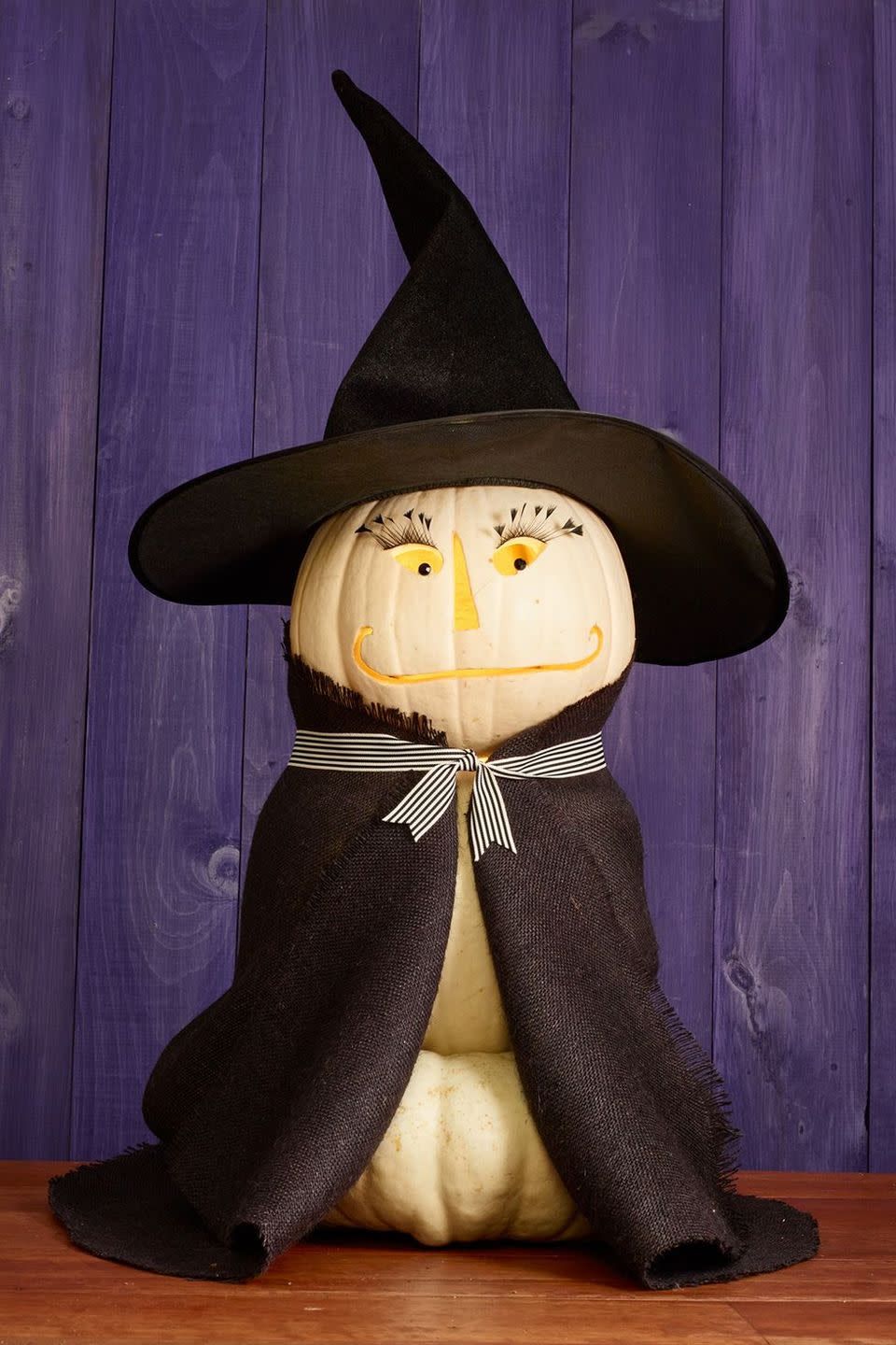 <p>Greet neighbors and trick-or-treaters with this bewitching pumpkin trio. Disguise the pumpkin stack with a black fabric cloak, finished off with a complementary ribbon. </p>