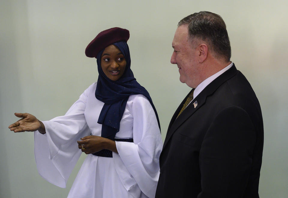 US Secretary of State Mike Pompeo, right, listens as "Startup Sunday" founder Mame Aminata Diambo gives him a tour of entrepreneurs who received assistance from the US Government programs, in Dakar, Senegal, Sunday, Feb. 16, 2020, part of Pompeo's first visit to sub-Saharan Africa during which he will seek to lay out a positive vision for US cooperation with the continent where China has been increasingly active. (Andrew Carballero-Reynolds/Pool Photo via AP)