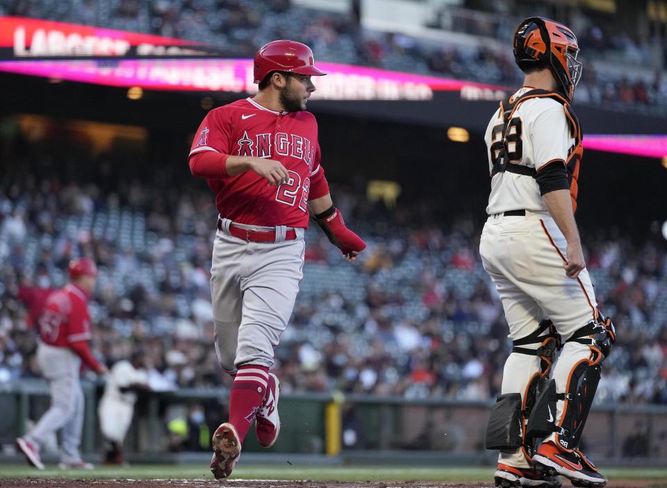 Los Angeles Angels' David Fletcher (22) scores a run past San Francisco Giants catcher Buster Posey on a single by Anthony Rendon during the third inning of a baseball game Tuesday, June 1, 2021, in San Francisco. (AP Photo/Tony Avelar)