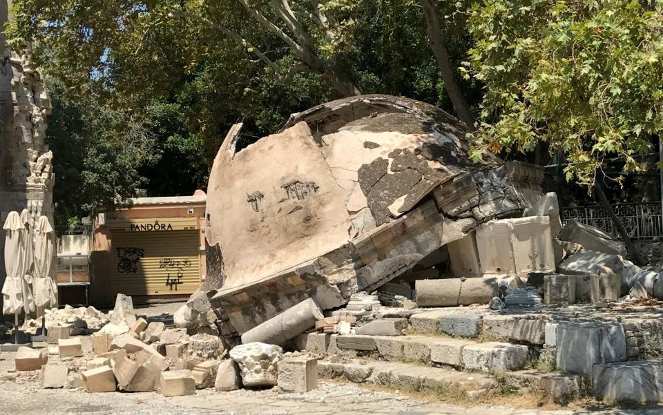 A damaged structure sits on the ground  - Credit: Michael Probst/AP