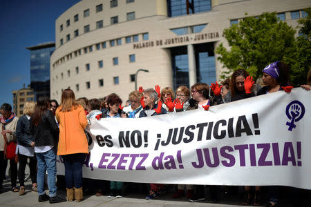 Protesters gather outside the High Court of Navarra behind a banner reading "No is No! Justice!" While awaiting a verdict on five men accused of the multiple rape of a woman during Pamplona's San Fermin festival in 2016, in Pamplona, Spain, April 26, 2018. REUTERS/Vincent West