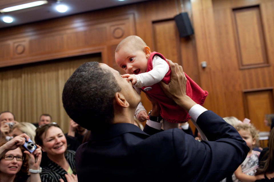 Obama lifts up a baby on April 4, 2009, during the U.S. Embassy greeting at a Prague hotel.