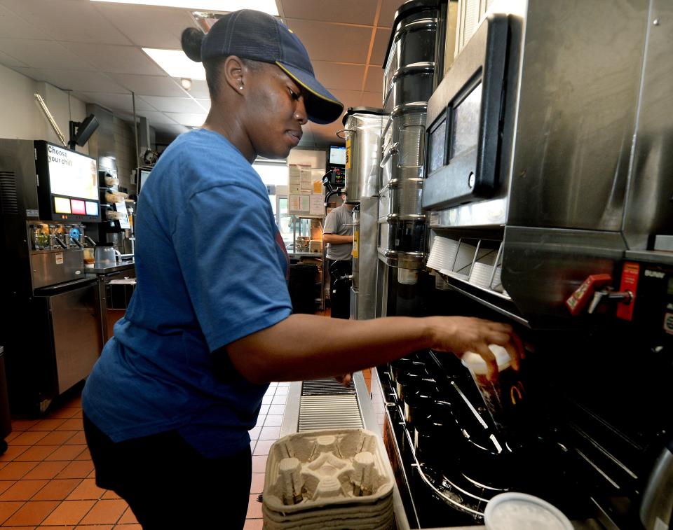 McDonald's employee Lesly Herring pulls out a drink from the automated beverage system at the South Sixth Street restaurant in Springfield on Thursday.