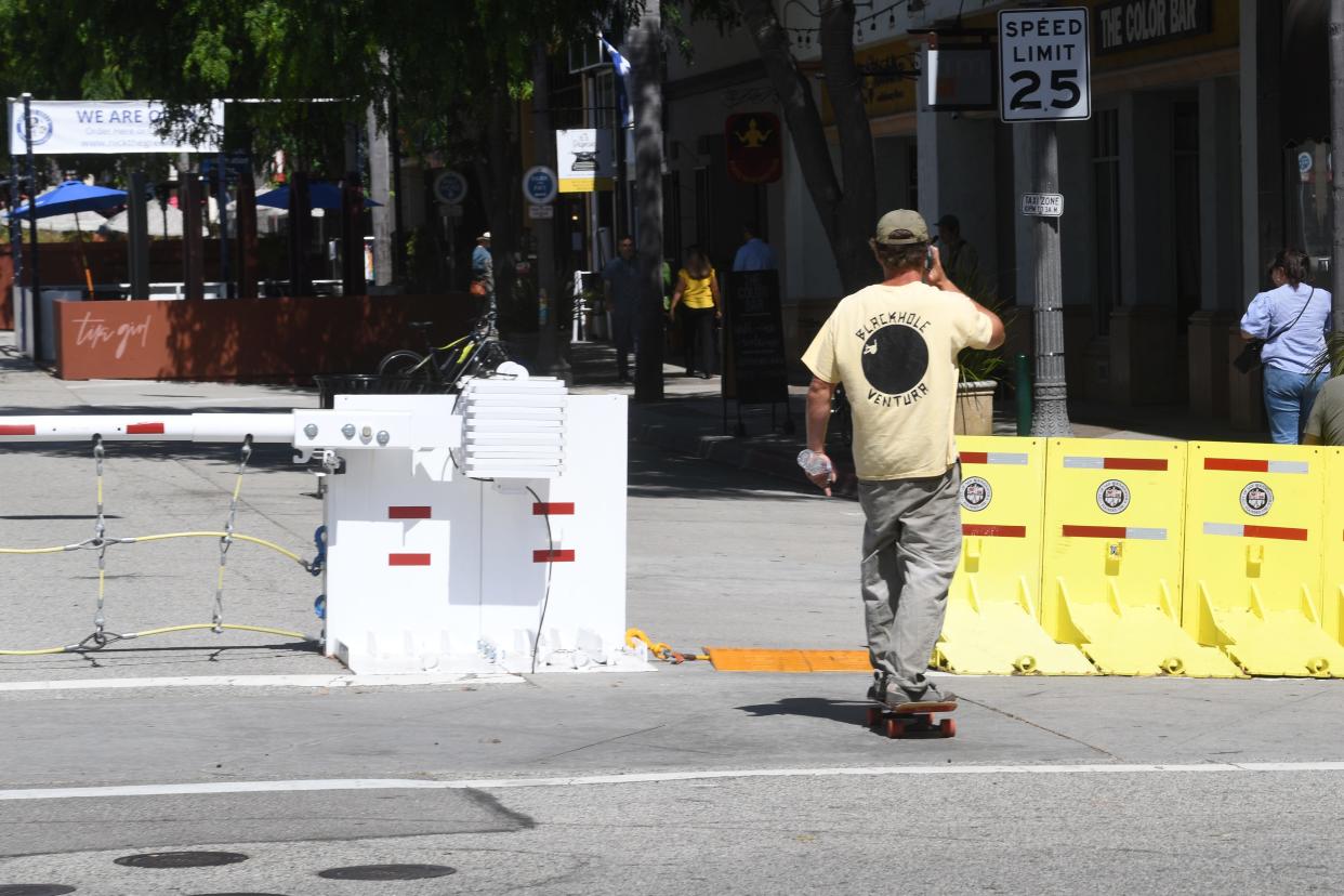 A man rides a skateboard through Main Street in downtown Ventura on June 21. Skateboards and bikes will no longer be allowed on Main Street starting Wednesday, July 26, 2023.