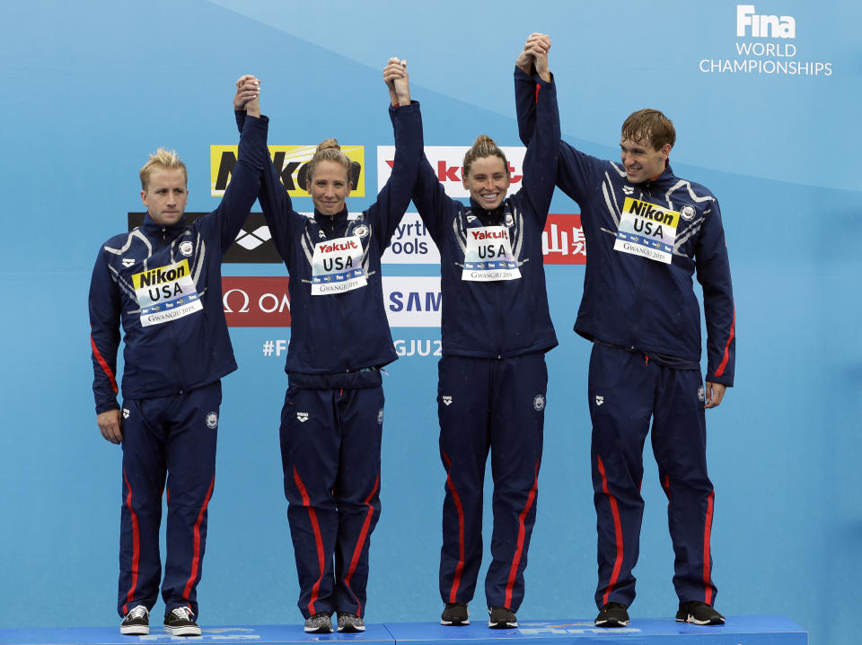 Members of the bronze medal-winning team from the United States stand on the podium after the 5km mixed relay open water swim at the World Swimming Championships in Yeosu, South Korea, Thursday, July 18, 2019. (AP Photo/Mark Schiefelbein)