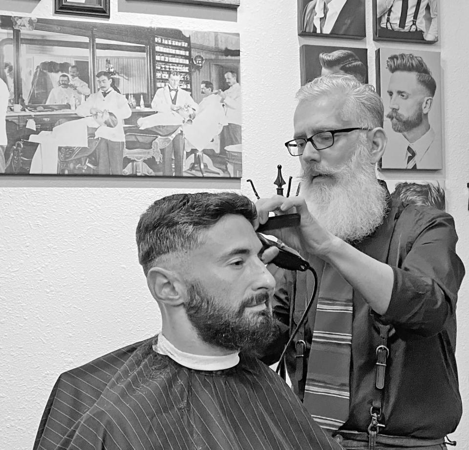Gentlemen's Barbershop Owner Nick Mischel (right) cuts customer Tony Harper's hair at Pueblo's only Prohibition-era barbershop, in the Union Depot.