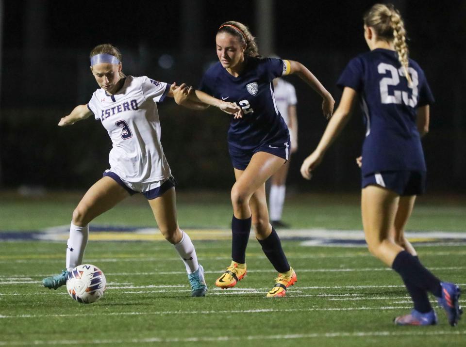 Estero Wildcats midfielder Kaitlyn Mancini (3) battles for possession with Naples Golden Eagles midfielder Lucy Froitzheim (12) during the first half of a game at Staver Field in Naples on Tuesday, Jan. 17, 2023.