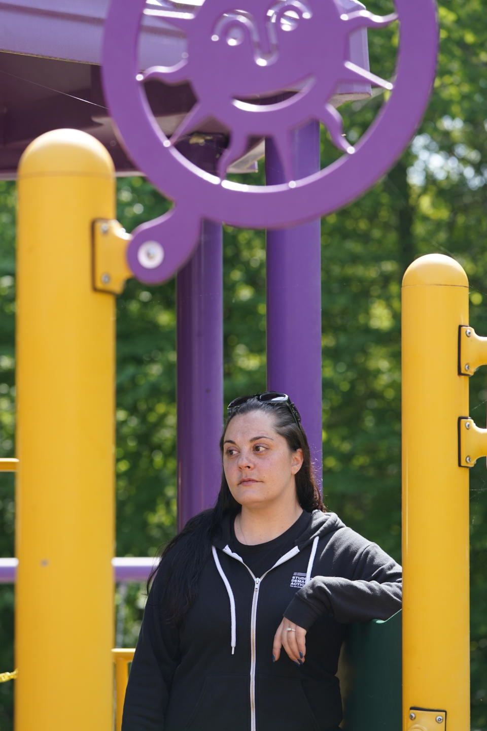 Erica Lafferty, whose mother Dawn Lafferty Hochsprung was killed during the Sandy Hook Elementary School shooting in 2012, poses for a picture on the playground honoring her mother in Watertown, Conn., Wednesday, May 25, 2022. A program manager at Everytown for Gun Safety and an advocate for universal background checks, Erica Lafferty said gains have been made quietly in states around the country. (AP Photo/Seth Wenig)