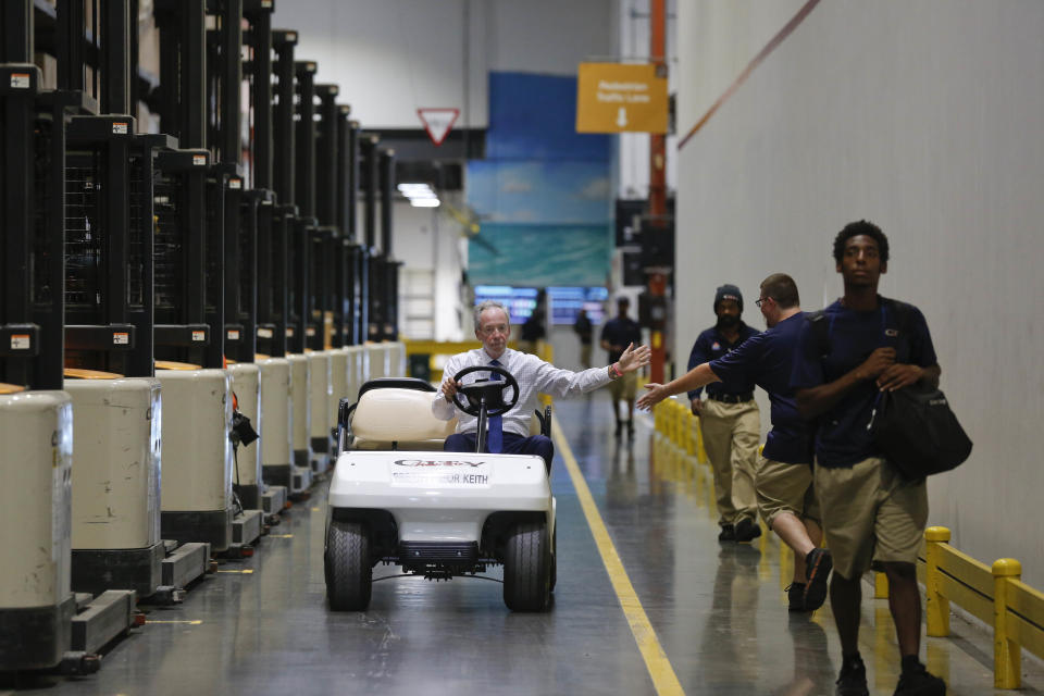 Keith Koenig, then-CEO of City Furniture (and now president), rides through his wear house giving high fives to the employees in Tamarac, Fla. on June 26, 2018. (Photo: AP:/Brynn Anderson)