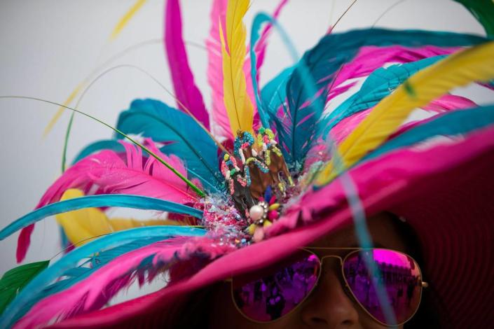 Amanda Ahlfeld's hat is highlighted by thoroughbred horses for the Kentucky Derby, from Lee Designs, in Louisville, Ky., Saturday, May 6, 2023.  Amy Wallot