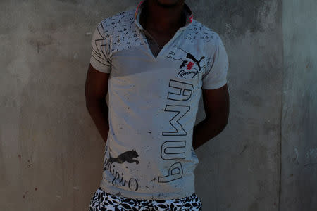 Lucasse Charnel, who was deported back to Haiti from the United States, poses for a portrait with the T-shirt he said he was wearing when detained in the U.S., at the house where he lives, in Port-au-Prince, Haiti, January 30, 2017. REUTERS/Andres Martinez Casares