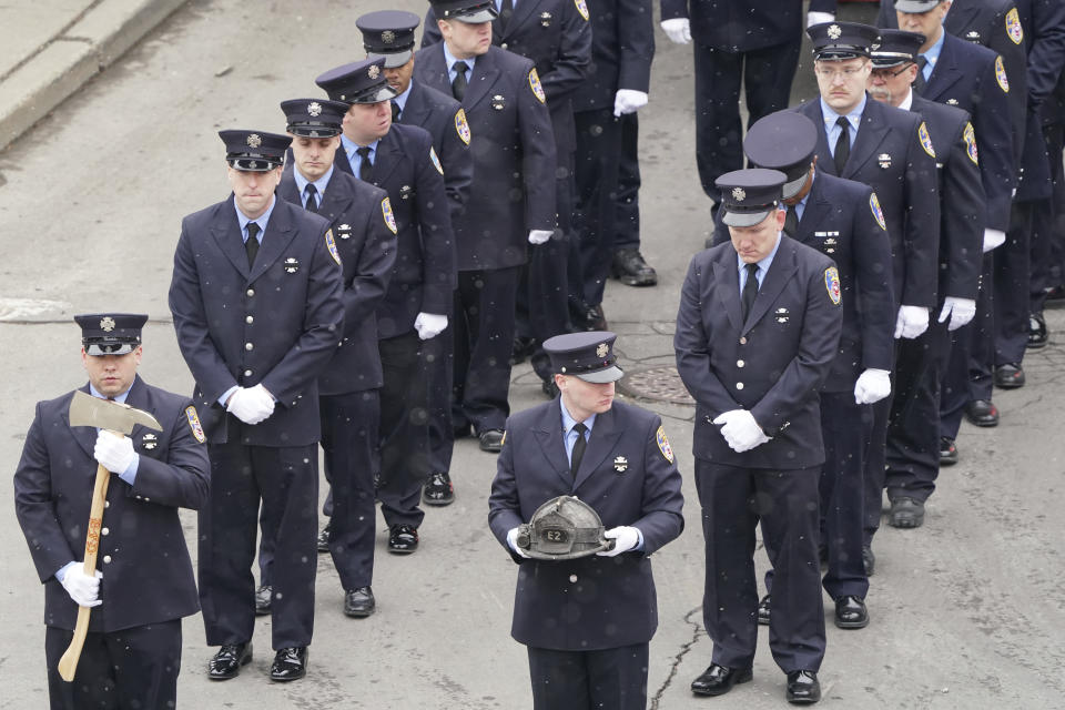 Firefighters from Engine Two line up in formation to escort Buffalo Firefighter Jason Arno to St. Joseph Cathedral in Buffalo, N.Y., on Friday, March 10, 2023. The 37-year-old father who had been with the department for three years was killed in an explosive blaze. (Derek Gee/The Buffalo News via AP)