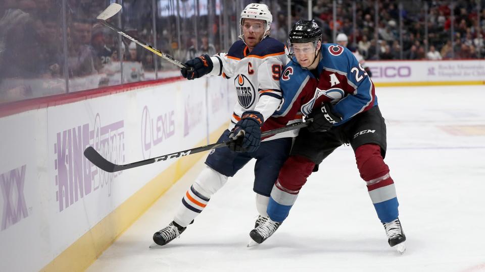 Connor McDavid of the Edmonton Oilers fights for the puck against Nathan MacKinnon of the Colorado Avalanche in the first period at the Pepsi Center on November 27, 2019 in Denver, Colorado. (Photo by Matthew Stockman/Getty Images)