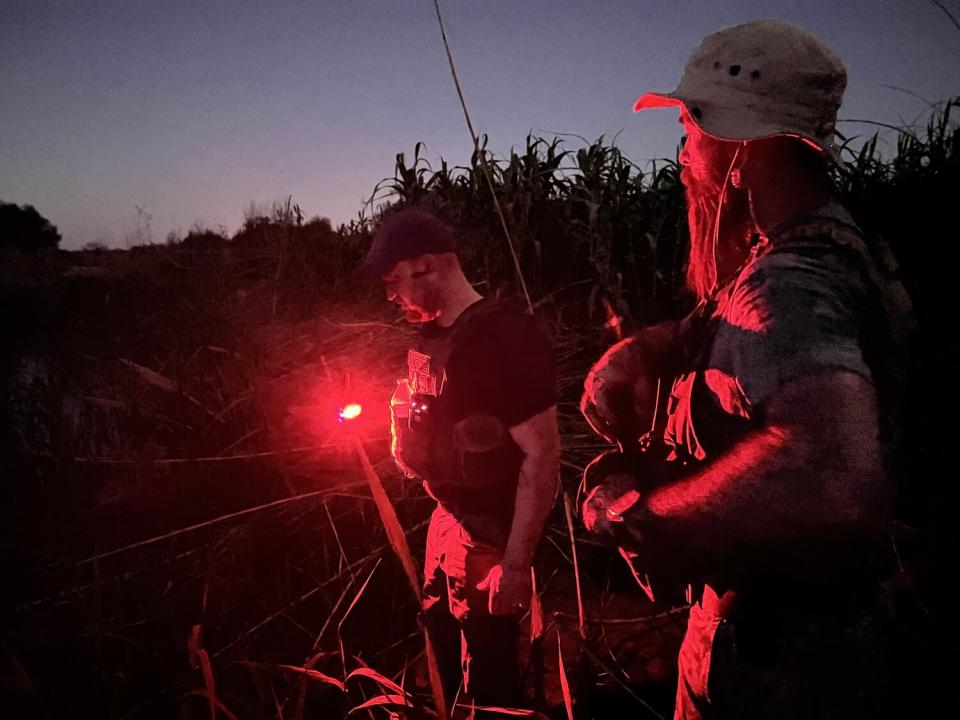 Samuel Hall, left, and Shawn Tredway patrol the Rio Grande near Border Patrol agents in Eagle Pass, Texas.