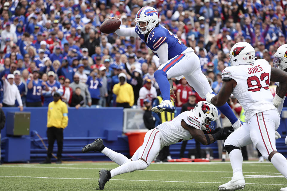 Buffalo Bills quarterback Josh Allen (17) leaps over Arizona Cardinals safety Budda Baker for a touchdown during the second half of an NFL football game Sunday, Sept. 8, 2024, in Orchard Park, N.Y. (AP Photo/Jeffrey T. Barnes)