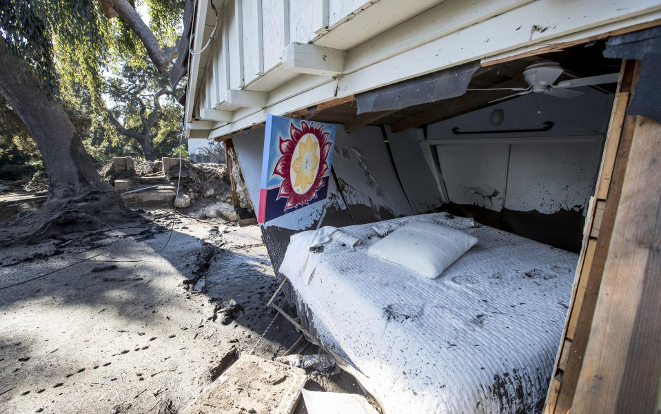 <p>Flood waters and mud pushed out the wall of a bedroom where a woman was reported missing by friends and family but was later found to be safe on Jan. 11, 2018 in Montecito, Calif. (Photo: Brian van der Brug/Los Angeles Times via Getty Images) </p>