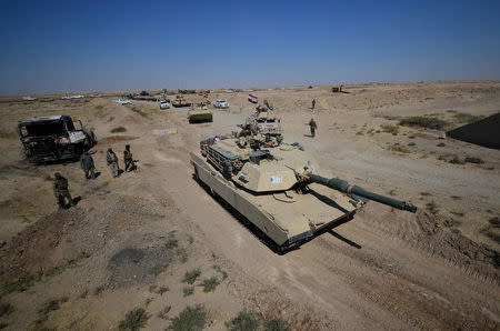 A tank of Iraqi army members and Shi'ite Popular Mobilization Forces (PMF) are seen in Al-Al-Fateha military airport south of Hawija, Iraq, October 2, 2017. REUTERS/Stringer