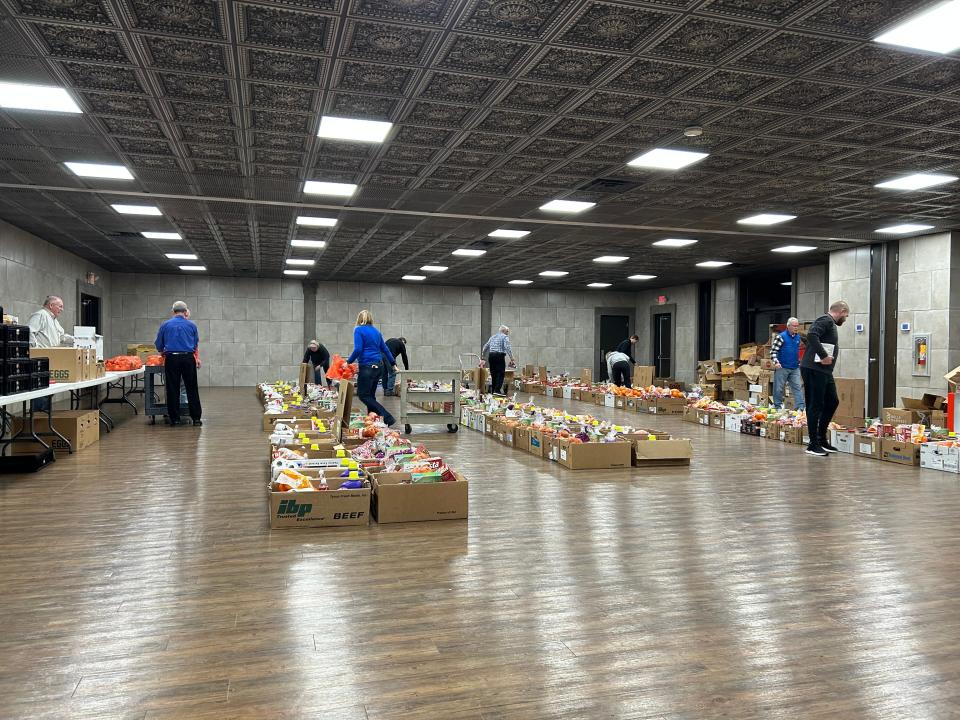 Tecumseh Service Club members pack boxes of food for their 2022 Christmas Sponsor-a-Family program at the Ashlar banquet hall in Tecumseh.