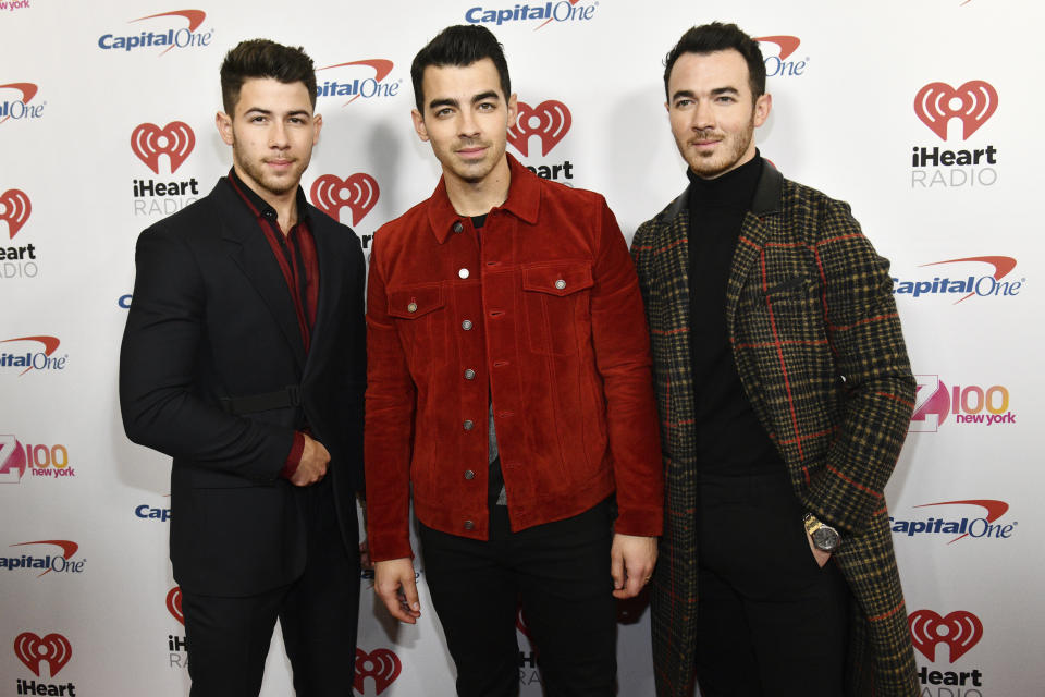 FILE - This Dec. 13, 2019 file photo shows Nick Jonas, left, Joe Jonas and Kevin Jonas from the Jonas Brothers at Z100's iHeartRadio Jingle Ball in New York. Stay-at-home orders, traveling fears and the cancellation of sporting events, concerts and theme parks have forced the Make-a-Wish foundation to come to a stand-still, leaving young people’s requests in holding patterns. The charity has introduced “Messages of Hope,” encouraging the public and celebrities to record inspiring messages and upload them to social media, and so far, stars like The Jonas Brothers have already participated. (Photo by Charles Sykes/Invision/AP, File)