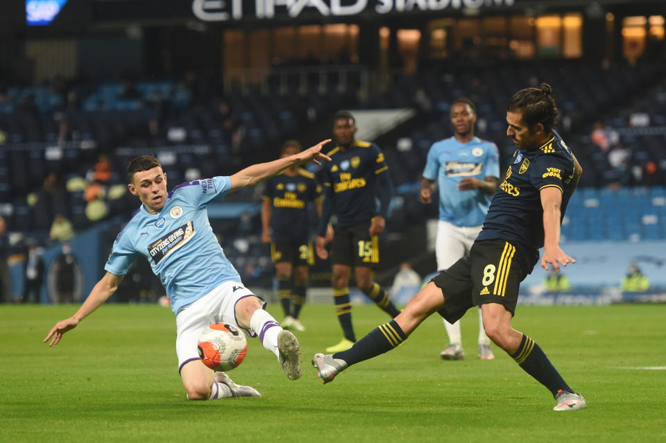 MANCHESTER, ENGLAND - JUNE 17: Phil Foden of Manchester City  battles for possession with Dani Ceballos of Arsenal during the Premier League match between Manchester City and Arsenal FC at Etihad Stadium on June 17, 2020 in Manchester, United Kingdom. (Photo by Peter Powell/Pool via Getty Images)